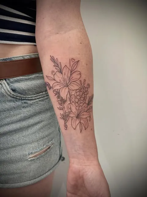 Floral fine-line forearm tattoo